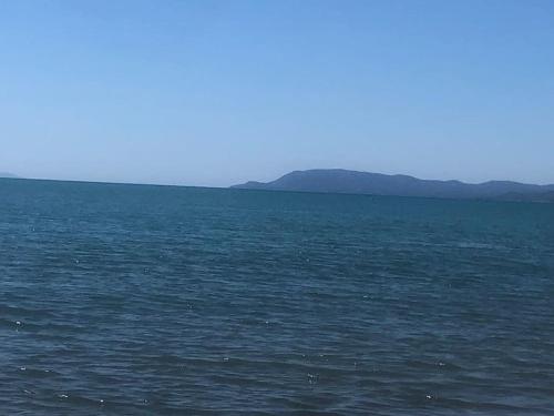a large body of water with mountains in the background at Casa Lucia a due passi dal mare Wi-Fi free parking in Principina a Mare