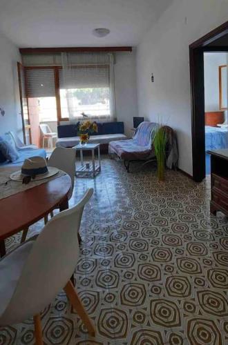a living room with a couch and a table at Casa Lucia a due passi dal mare Wi-Fi free parking in Principina a Mare