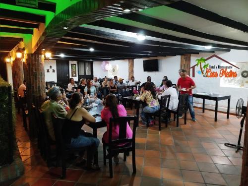 a group of people sitting at tables in a restaurant at Hotel y Restaurante Casa Medina in La Plata