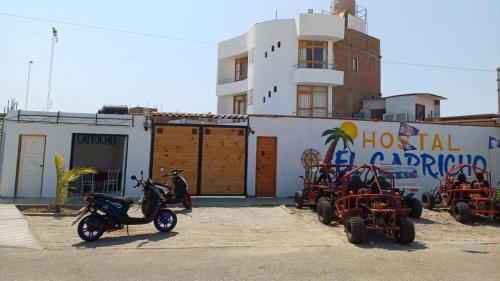 a group of motorcycles parked in front of a building at El Capricho II Paracas in Paracas