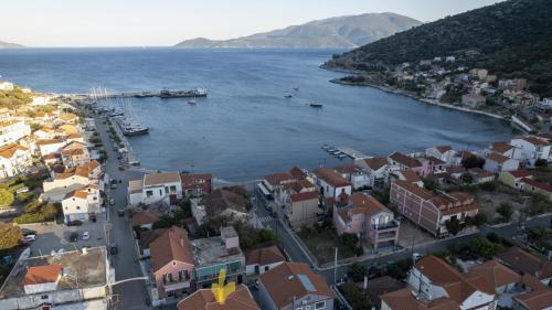 an aerial view of a town next to a body of water at Nicole Studios in Agia Effimia