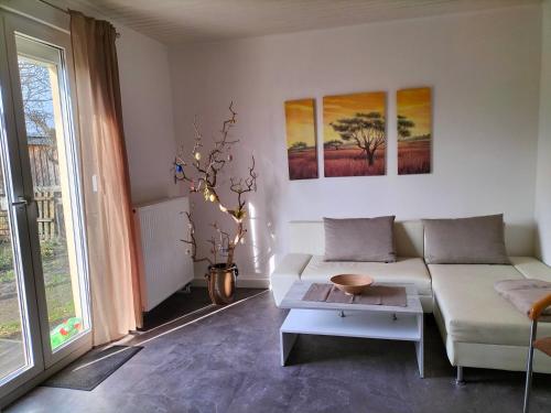 a living room with a couch and a table at Pension Rosenvilla in Sedlitz