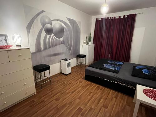 a bedroom with a bed and two stools in it at MONFas APARTMENT GARDEN CITY in Prague