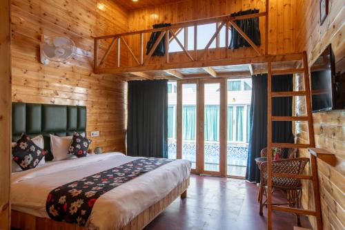 a bedroom with a loft bed and a ladder at Bayview Resort in Anjuna