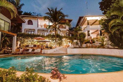 a swimming pool in front of a building at Casas Kismet in Nosara