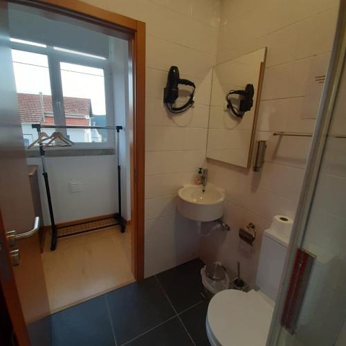 a bathroom with a toilet and a sink at Casas da Escola - "A Escola" - Meãs in Pampilhosa da Serra