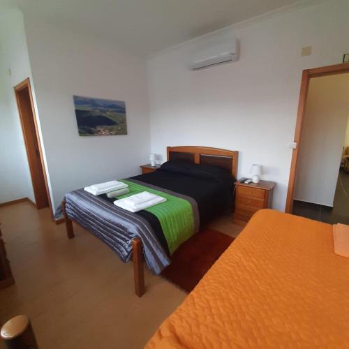 a bedroom with two beds and a mirror at Casas da Escola - "A Escola" - Meãs in Pampilhosa da Serra