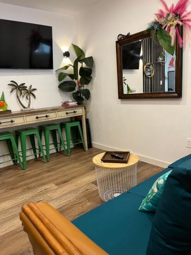 a living room with a couch and a mirror at Stunning Little Havana Suites Close to Calle Ocho, Brickell and Wynwood and 10 mins to the Beaches - Free Parking in Miami