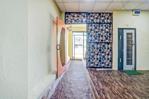 an empty hallway of an empty building with a door at Hotel O Radhe Krishna in Nagpur
