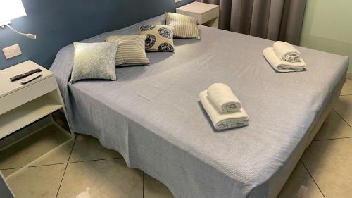 a bed with towels and pillows on it at A casa di Emma (camera Levante) in Sestri Levante