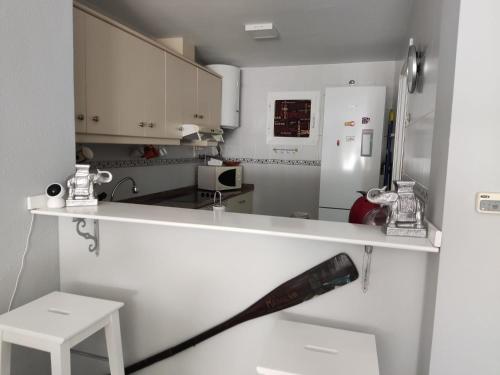 La cuisine est équipée d'un comptoir blanc et d'un réfrigérateur. dans l'établissement Fantástico apartamento VFT MA 75455, à Manilva