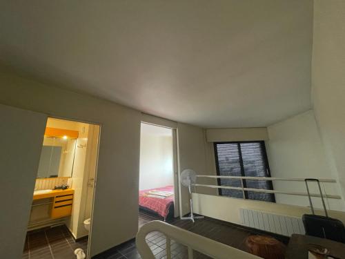 a small bedroom with a bed and a balcony at Étage d’un duplex au 17ème arr de Paris , vue sur le Défense, à 10min des champs Élysée in Paris