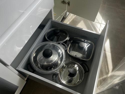 a drawer with four pots and pans in a kitchen at apartamento luxury en Fuengirola in Fuengirola