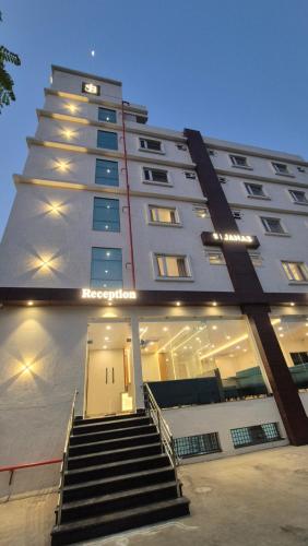 a tall building with stairs in front of it at Hotel JANAS in Tirupati