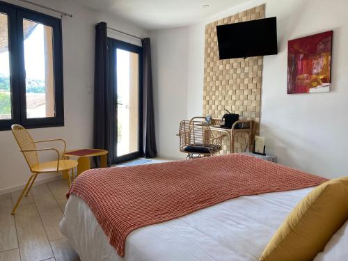 a bedroom with a bed and a television on the wall at Casa Santa Giulia in Propriano