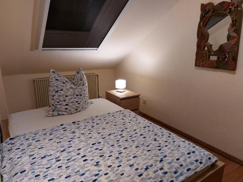 a bedroom with a bed with a pillow and a mirror at Ferienwohnung Jäger in Viereth-Trunstadt
