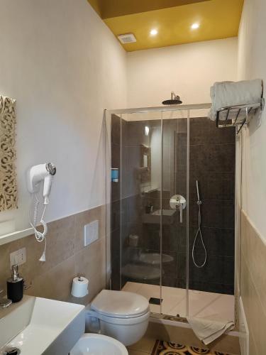 a bathroom with a shower and a toilet and a sink at Gala Sardinia in Cagliari