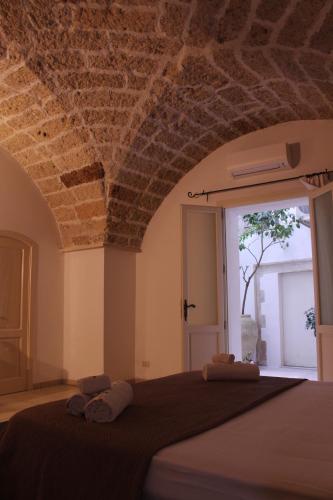 a bedroom with a bed with two towels on it at Corte Taddeo B&B in Galatina