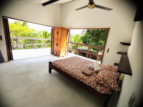 a bedroom with a bed and a large window at La Caracola Cartagena in Cartagena de Indias