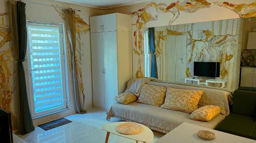 a living room with a couch and a tv at Sweet harmony in Belgrade