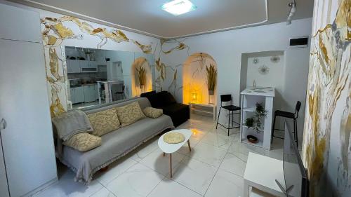 a living room with a couch and a kitchen at Sweet harmony in Belgrade