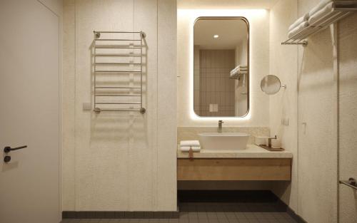 a bathroom with a sink and a mirror at Kvareli Lake Resort in Kvareli