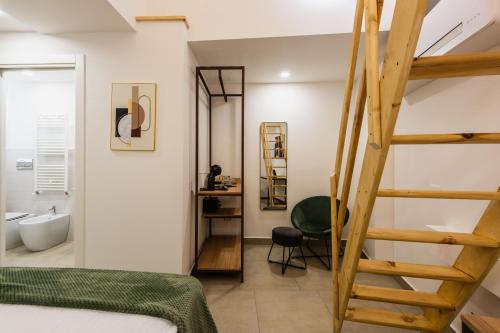 a bedroom with a ladder leading to a bathroom at Case Varanni Etna Experience in Viagrande