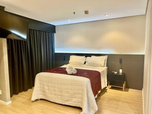 a bedroom with a large bed in a room at Radisson Premium Faria Lima in Sao Paulo