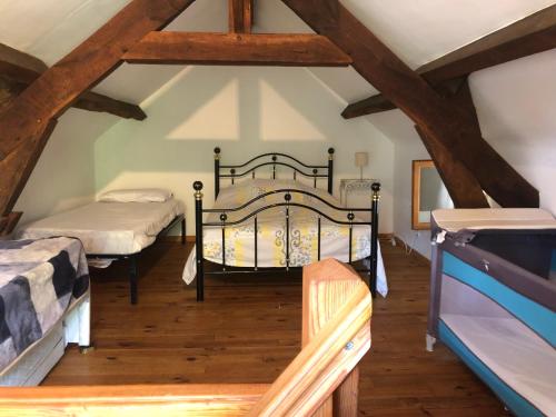 a bedroom with two beds in a attic at 1 Bedroom Tranquil Cottage Fishing by the lake in Bommiers