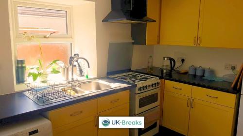 a kitchen with a sink and a stove at Pet-friendly holiday home in Egremont