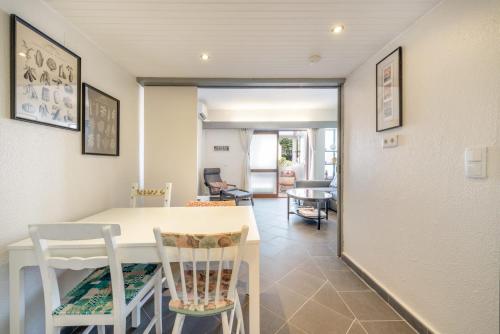 a kitchen and dining room with a table and chairs at Montebella at Portuguese Riviera ESTORIL in Estoril