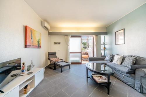a living room with a couch and a table at Montebella at Portuguese Riviera ESTORIL in Estoril