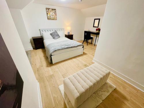 a small bedroom with a bed and a desk at Cambridge Heritage Apartments in Cambridge