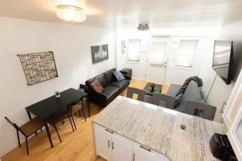 a living room with a couch and a table at Charming 2-Bed Apt Mins from NYC - Sleeps 7 in Union City