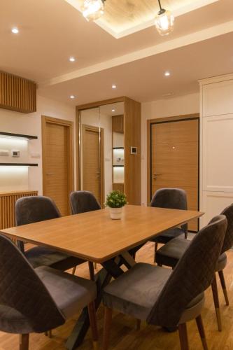 a conference room with a wooden table and chairs at Tara Lux apartmani in Kaludjerske Bare