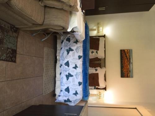 a bathroom with a pile of towels on a wall at Villa Valencia in Pinetown