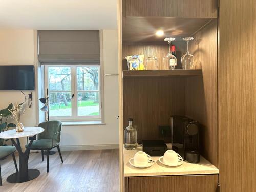 a living room with a table and a dining room at Hotel Flora Batava in Breukelen