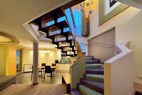 a spiral staircase in a building with a dining room at Grütter Luxury Apartments in Ischgl
