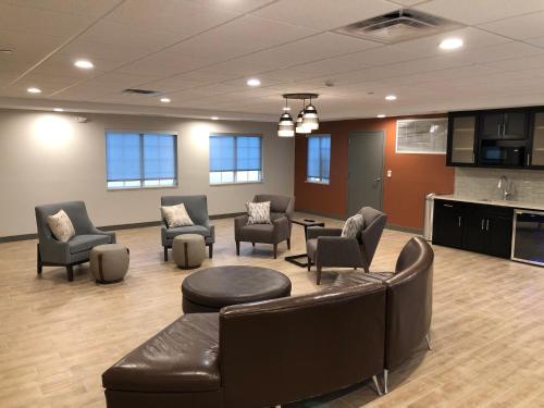 a waiting room with couches and chairs and a table at Candlewood Suites Fort Wayne - NW by IHG in Fort Wayne