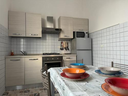 a kitchen with a table with bowls on it at La casa di Carlotta in Ceparana