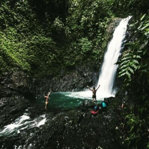 a person standing in front of a waterfall at Habitaciones en chalet cerca de san cipriano y las chorreras de perico in Buenaventura