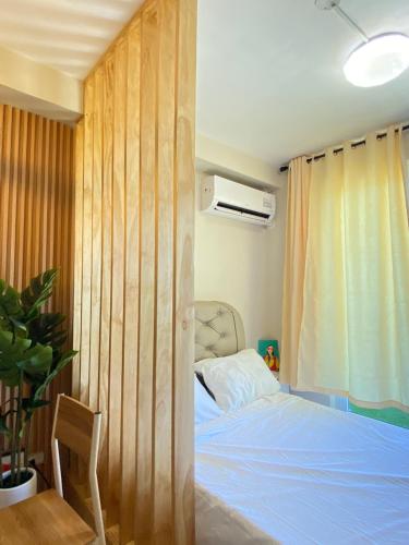 a bedroom with a bed and a wooden wall at Saekyung Village1, Phase 3, Marigondon, Lapu-Lapu City, Cebu in Lapu Lapu City