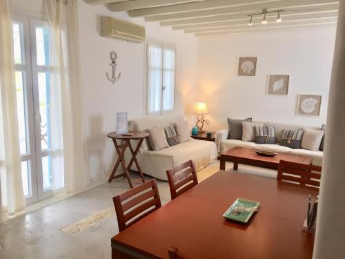 a living room with a couch and a table at Anthos House in Ornos