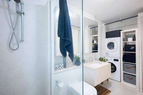a bathroom with a toilet and a sink and a shower at Balmain Designer 1 Bedroom Apartment with Parking in Sydney