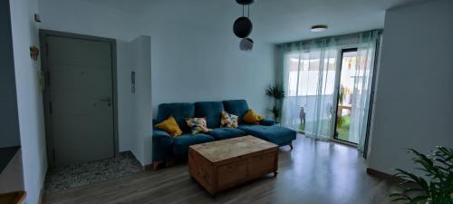 Sala de estar azul con sofá azul y mesa en Apartamento El dragoncillo del Cabo, en Las Negras