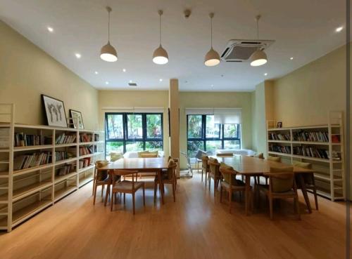 a dining room with a table and chairs and bookshelves at seaview beach 4-13pax/CIQ 5mins/ johor bahru ambersite in Johor Bahru