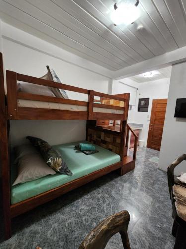 a bedroom with two bunk beds in a room at ASHBURN'S TRANSIENT Bauang La Union - MOTORCYCLE PARKING ONLY in Lossoc