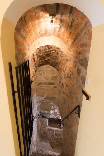 an archway of a brick building with a gate at ApartOne Altstadt-Hotel in Bautzen