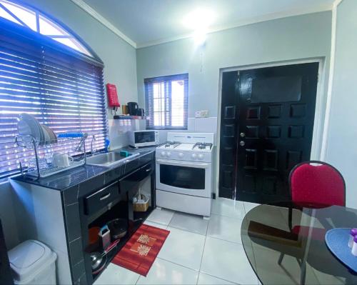 a kitchen with a sink and a stove at Jobs Inn Jamaica in Montego Bay