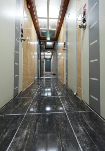 a hallway with doors and a tile floor at 9-RoD in Seoul